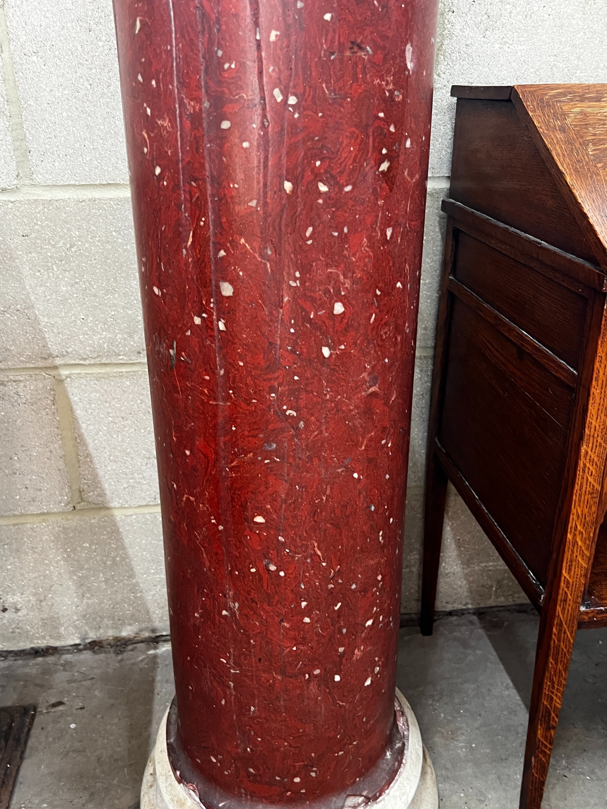 A faux porphyry column with circular marble top, height 104cm